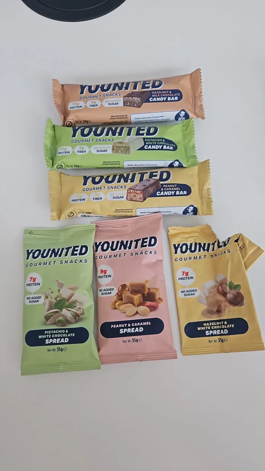 Physical YOUNITED candy bar and spread samples laid out on a table
